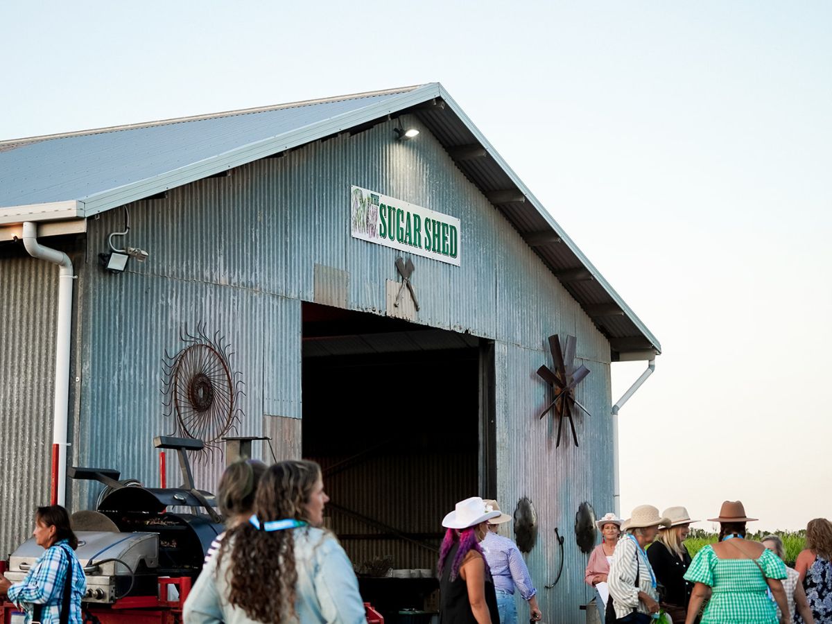 A group of people enjoying a country themed social event at a barn