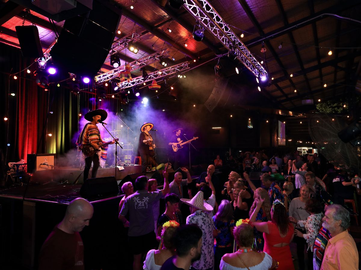 Group of masters competitors dancing to a band at a social event