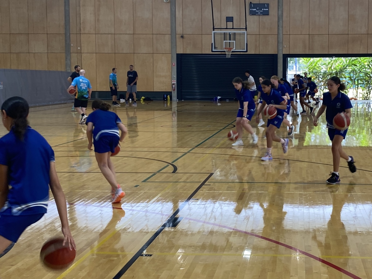 Young students dribbling basketballs