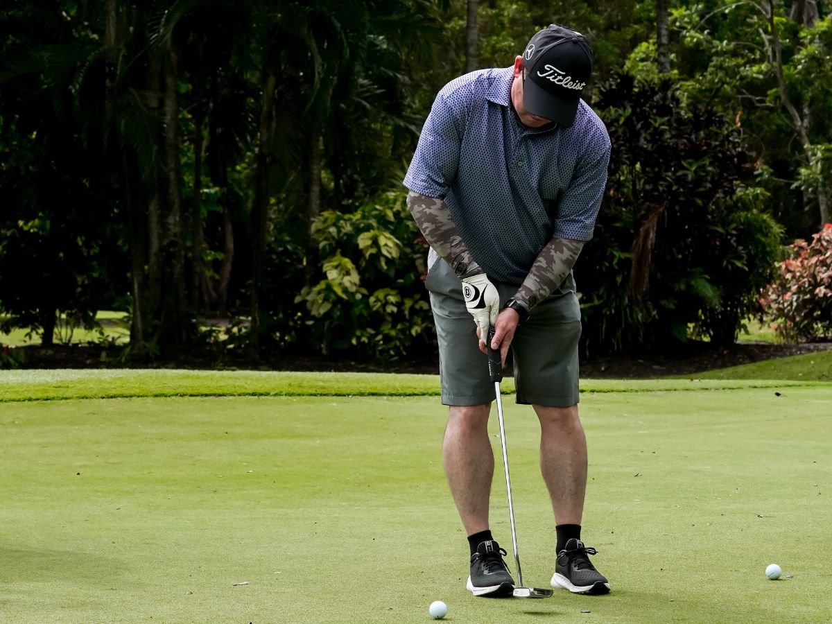 Masters man putting golf ball