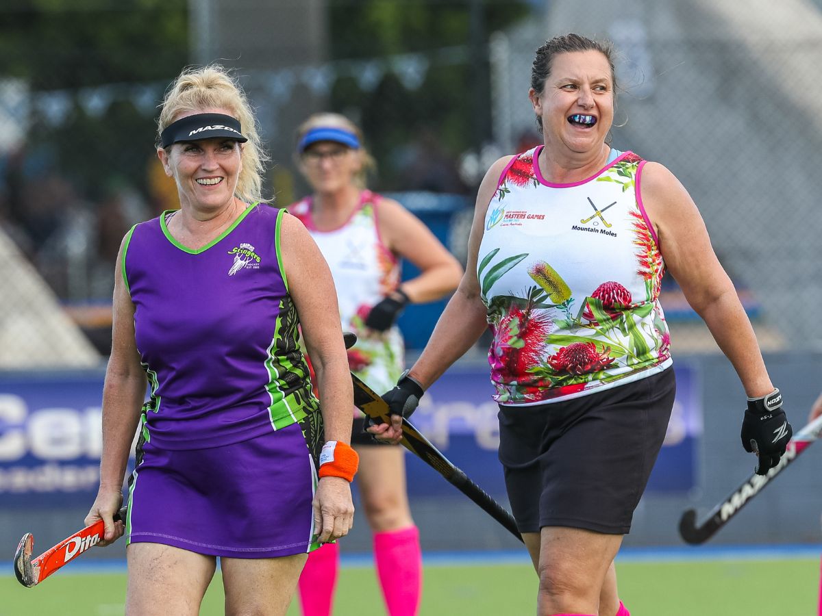 Masters women smiling on hockey field
