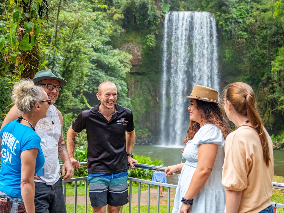 A couple watching a crocodile being fed at a wildlife sanctuary
