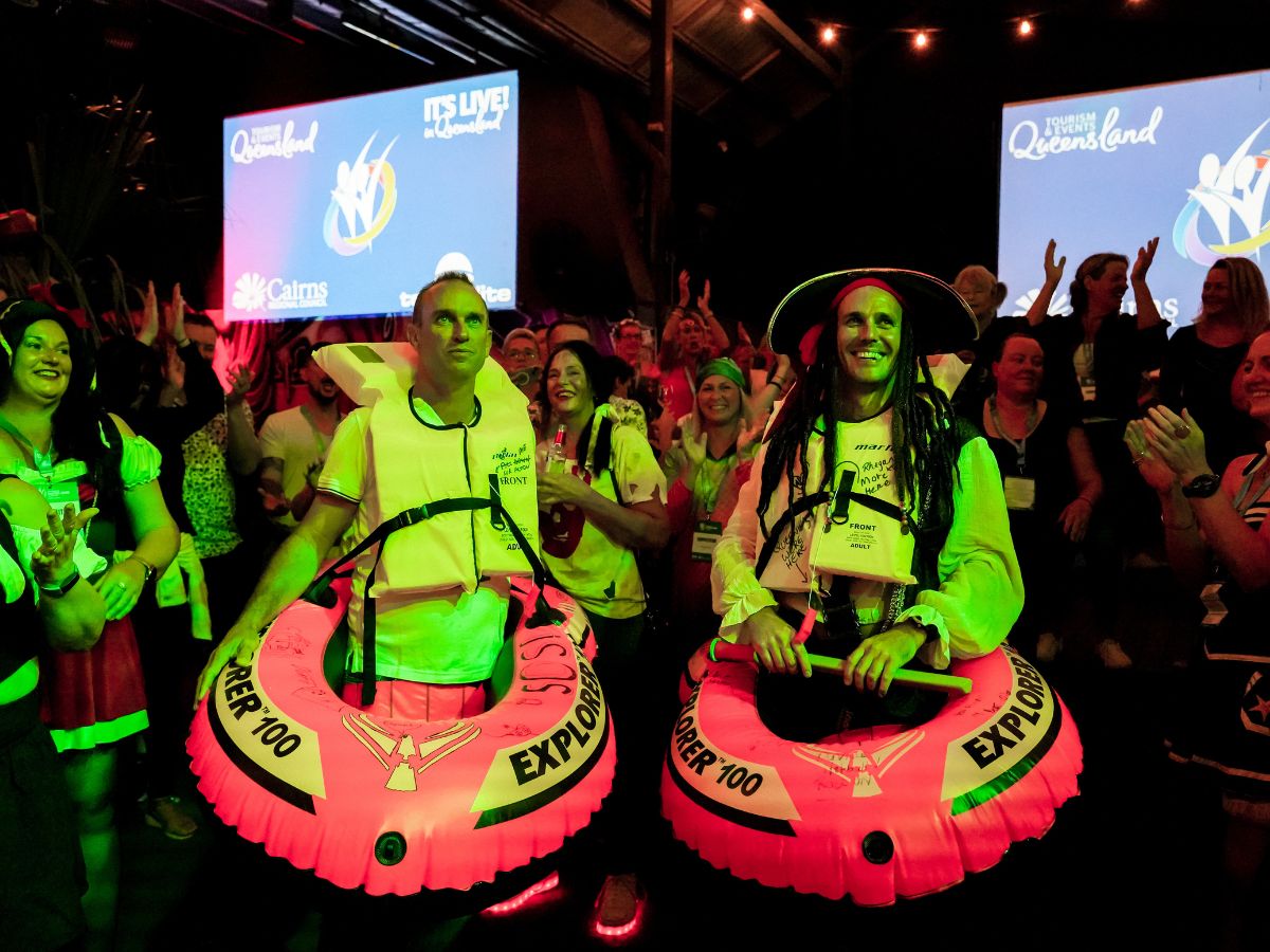 Two men dressed as pirates posing for a photo at an event