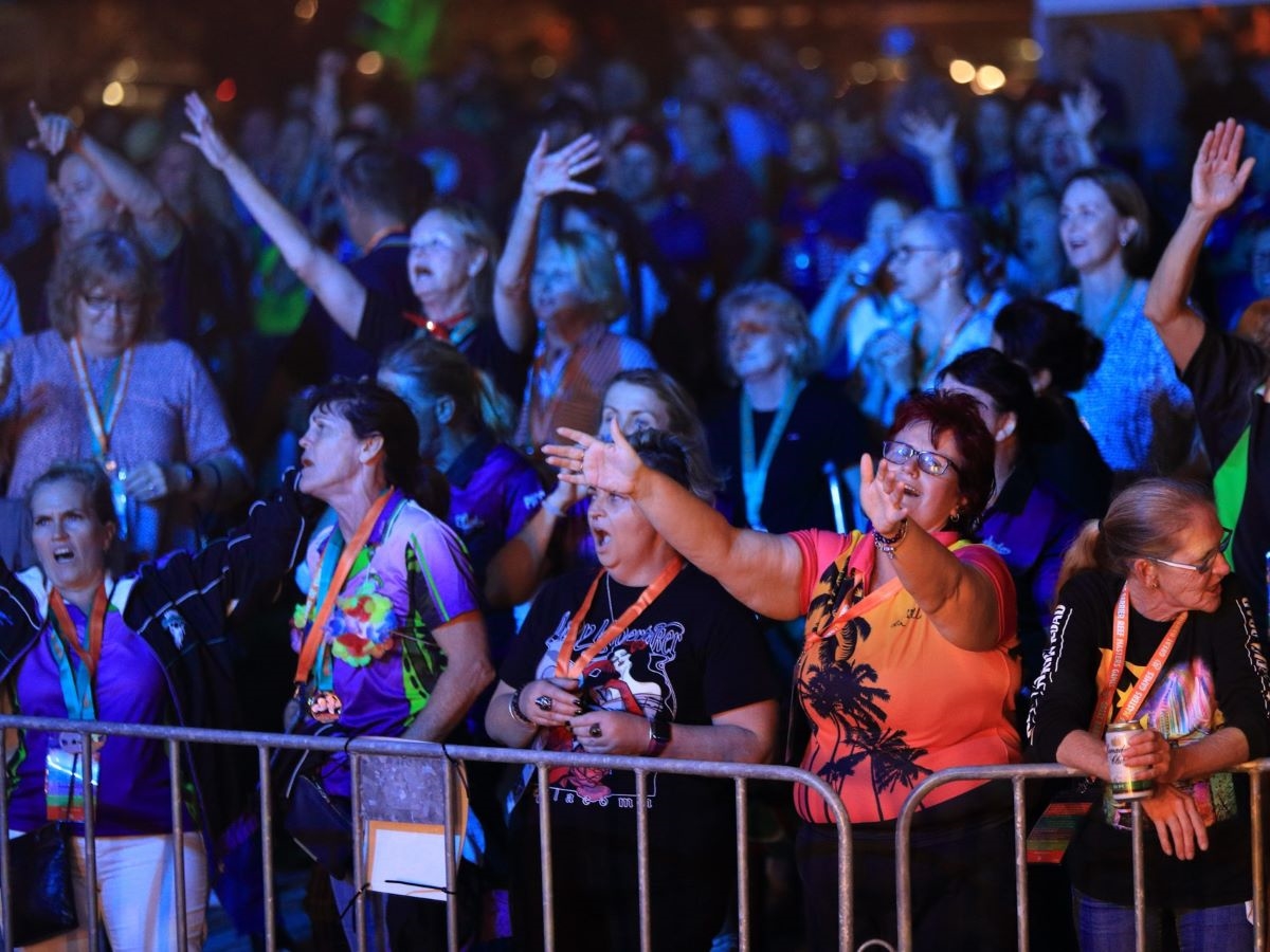 Competitors at a lively party, singing and dancing