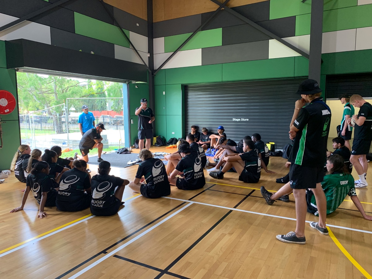 Group of students engaged in rugby league clinic